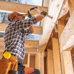 construction worker securing wood beams with hamme 2026 03 20 03 23 08 utc