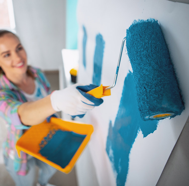 woman painting wall with blue paint in home 2026 04 14 01 58 41 utc